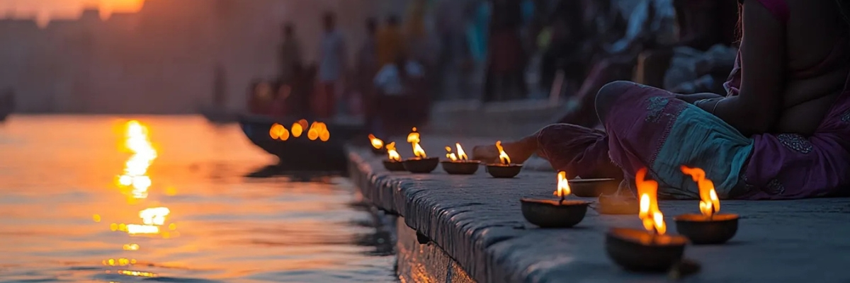 Burning diya on a ghat side symbolising devotion and spiritual reflection